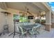 This covered patio features a dining table set, ceiling fans, and an outdoor television, perfect for entertaining at 2244 Garden City Ave, Henderson, NV 89052