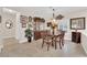 Traditional dining room with china cabinet, wood table and seating, chandelier, and neutral walls at 2244 Garden City Ave, Henderson, NV 89052