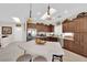 Kitchen with a white countertop island, stainless steel appliances, and dark wood cabinets at 2244 Garden City Ave, Henderson, NV 89052