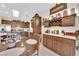 Well-lit kitchen featuring wood cabinets, stainless steel appliances, and a skylight, offering a warm and inviting space at 2244 Garden City Ave, Henderson, NV 89052