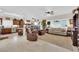 Open-concept living room featuring a large neutral-colored sofa, tile flooring, and plenty of natural light at 2244 Garden City Ave, Henderson, NV 89052