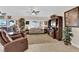 Inviting living room with cozy seating, a ceiling fan, and natural light from the large window at 2244 Garden City Ave, Henderson, NV 89052