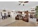 Open-concept living area with tile flooring, a cozy seating arrangement, and seamless flow to the kitchen and dining areas at 2244 Garden City Ave, Henderson, NV 89052