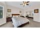 Comfortable main bedroom with neutral tones, carpet flooring, ceiling fan and mirrored closet, promoting a relaxing atmosphere at 2244 Garden City Ave, Henderson, NV 89052