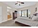 Charming main bedroom featuring French doors leading to the backyard, a ceiling fan and adjoining bathroom at 2244 Garden City Ave, Henderson, NV 89052