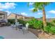 Back patio features outdoor dining and seating area with lush landscaping and privacy at 2244 Garden City Ave, Henderson, NV 89052