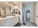 Bathroom featuring double sinks, updated hardware, and a walk in closet at 225 Sul Ponticello Ave, Las Vegas, NV 89011