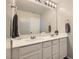 Bathroom featuring double sinks, updated hardware, and a large mirror at 225 Sul Ponticello Ave, Las Vegas, NV 89011