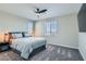 Cozy bedroom with plush carpet, ceiling fan, and a large window at 225 Sul Ponticello Ave, Las Vegas, NV 89011