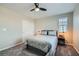 Comfortable bedroom with plush carpet, ceiling fan, and a large window at 225 Sul Ponticello Ave, Las Vegas, NV 89011