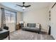 Bedroom features a window, carpeting, a ceiling fan, and a sofa at 225 Sul Ponticello Ave, Las Vegas, NV 89011