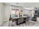 Charming dining area features modern table and chairs with a view to the outdoor patio at 225 Sul Ponticello Ave, Las Vegas, NV 89011