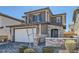 Two story home with stone facade, two car garage, landscaped yard, and covered front porch at 225 Sul Ponticello Ave, Las Vegas, NV 89011