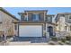 Charming two-story home featuring stone accents, a two-car garage, and manicured landscaping at 225 Sul Ponticello Ave, Las Vegas, NV 89011