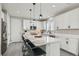 Well-lit kitchen features white cabinetry, a quartz island, stainless steel appliances, and pendant lights at 225 Sul Ponticello Ave, Las Vegas, NV 89011