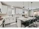 Modern kitchen with white countertops, stainless steel appliances, island with breakfast bar, and sleek fixtures at 225 Sul Ponticello Ave, Las Vegas, NV 89011