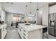 Open concept kitchen and dining area features large island, white cabinets, and stainless steel appliances at 225 Sul Ponticello Ave, Las Vegas, NV 89011