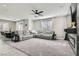 Spacious living room featuring neutral colors, a ceiling fan, and carpeted flooring at 225 Sul Ponticello Ave, Las Vegas, NV 89011