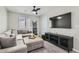 Comfortable living area featuring a sectional sofa, ceiling fan and modern entertainment center at 225 Sul Ponticello Ave, Las Vegas, NV 89011