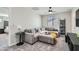 Comfortable living room featuring carpeting, a ceiling fan, and a large sofa at 225 Sul Ponticello Ave, Las Vegas, NV 89011