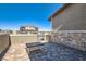 Private patio with stone wall and pavers, perfect for outdoor relaxation and entertaining at 225 Sul Ponticello Ave, Las Vegas, NV 89011