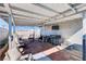 Covered back patio features an outdoor television and a ceiling with painted support beams at 2345 Steinke Ln, Las Vegas, NV 89108