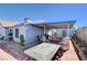 Exterior view of covered patio and backyard with brick pavers and outdoor seating area at 2345 Steinke Ln, Las Vegas, NV 89108