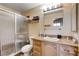 Well-lit bathroom with a glass-enclosed shower and a vanity with a granite countertop and ample storage at 2345 Steinke Ln, Las Vegas, NV 89108