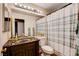 Bathroom featuring tile flooring, a wooden vanity with sink, and a shower-tub combo with curtain at 2345 Steinke Ln, Las Vegas, NV 89108