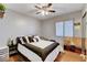 This bedroom features a ceiling fan, window, and a large bed with black and white bedding at 2345 Steinke Ln, Las Vegas, NV 89108