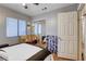 Bedroom featuring ceiling fan, window with blinds, mirrored closet doors, and neutral wall color at 2345 Steinke Ln, Las Vegas, NV 89108