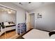 Bedroom showcasing a large window, mirrored closet doors, and view into another room at 2345 Steinke Ln, Las Vegas, NV 89108