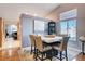 Bright dining area featuring a modern table and chairs, and large windows with natural light at 2345 Steinke Ln, Las Vegas, NV 89108