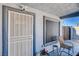 Inviting covered porch with a decorative storm door and seating area at 2345 Steinke Ln, Las Vegas, NV 89108