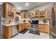 Bright kitchen featuring wood cabinets, stainless steel appliances, and marble flooring at 2345 Steinke Ln, Las Vegas, NV 89108