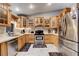 Bright kitchen features wood cabinetry, stainless steel appliances, and marble-look floors at 2345 Steinke Ln, Las Vegas, NV 89108