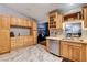 Kitchen with light wood cabinets, marble-look floors, and stainless steel dishwasher at 2345 Steinke Ln, Las Vegas, NV 89108