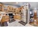 View of kitchen featuring wood cabinets, stainless steel refrigerator, and marble-look floors at 2345 Steinke Ln, Las Vegas, NV 89108