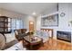 Cozy living room with a fireplace, an exterior door, hardwood floors, and neutral-colored sofas at 2345 Steinke Ln, Las Vegas, NV 89108