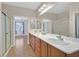 Bathroom with double sinks, vanity, walk-in shower, and natural light at 2405 Gamma Ray Pl, Henderson, NV 89044