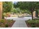 Outdoor community space with table, chairs, landscaping, and shade at 2405 Gamma Ray Pl, Henderson, NV 89044