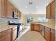 Well-lit kitchen featuring a breakfast bar and stainless steel appliances at 2405 Gamma Ray Pl, Henderson, NV 89044