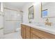 Bright bathroom featuring double vanity, marble countertops, and glass enclosed shower at 2415 La Estrella St, Henderson, NV 89014