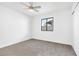 Bright bedroom featuring neutral carpet, a ceiling fan, and a window providing natural light at 2415 La Estrella St, Henderson, NV 89014