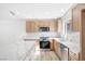 Bright kitchen featuring stainless steel appliances, wood cabinets and a marble island at 2415 La Estrella St, Henderson, NV 89014