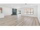 Bright living room with modern flooring, stone fireplace, and access to the backyard at 2415 La Estrella St, Henderson, NV 89014