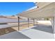 A covered patio with a neutral toned concrete floor and a retaining wall at 2415 La Estrella St, Henderson, NV 89014