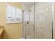 Modern bathroom features a glass enclosed shower with marble-like tiling and bright natural light at 255 El Camino Verde St, Henderson, NV 89074