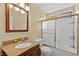 Bathroom with a granite countertop, wood cabinets, and a shower and tub combination at 255 El Camino Verde St, Henderson, NV 89074