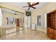 Bedroom with a ceiling fan, mirrored closet, and a wooden cabinet at 255 El Camino Verde St, Henderson, NV 89074